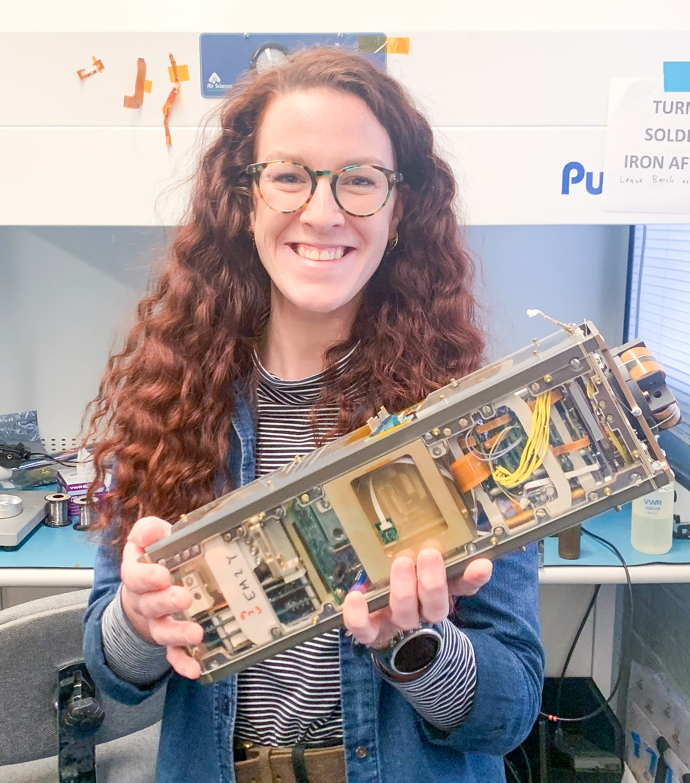 Profile picture of Frances Staples holding a flight model of the ELFIN cubesat